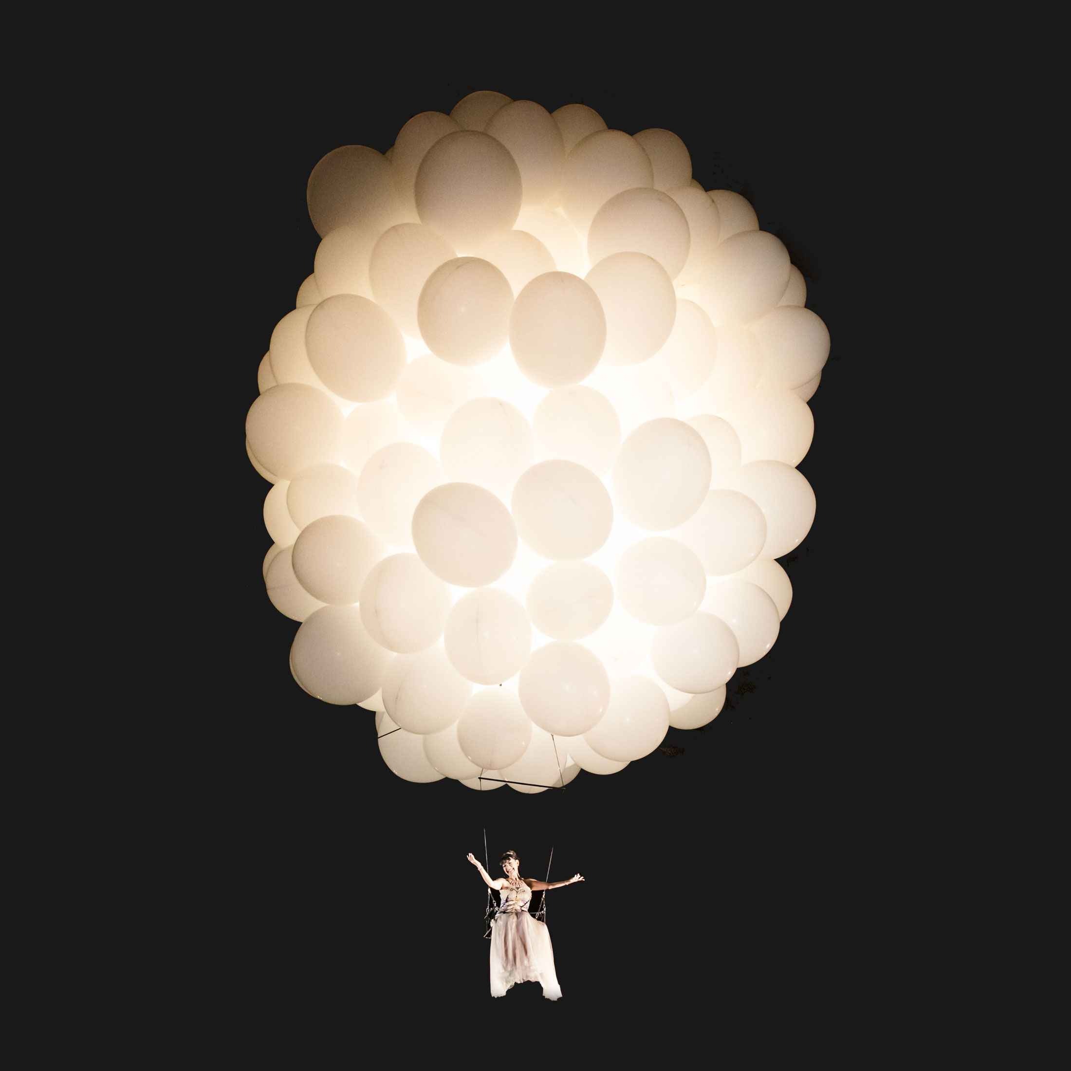 Opera singer suspended in the sky by balloons