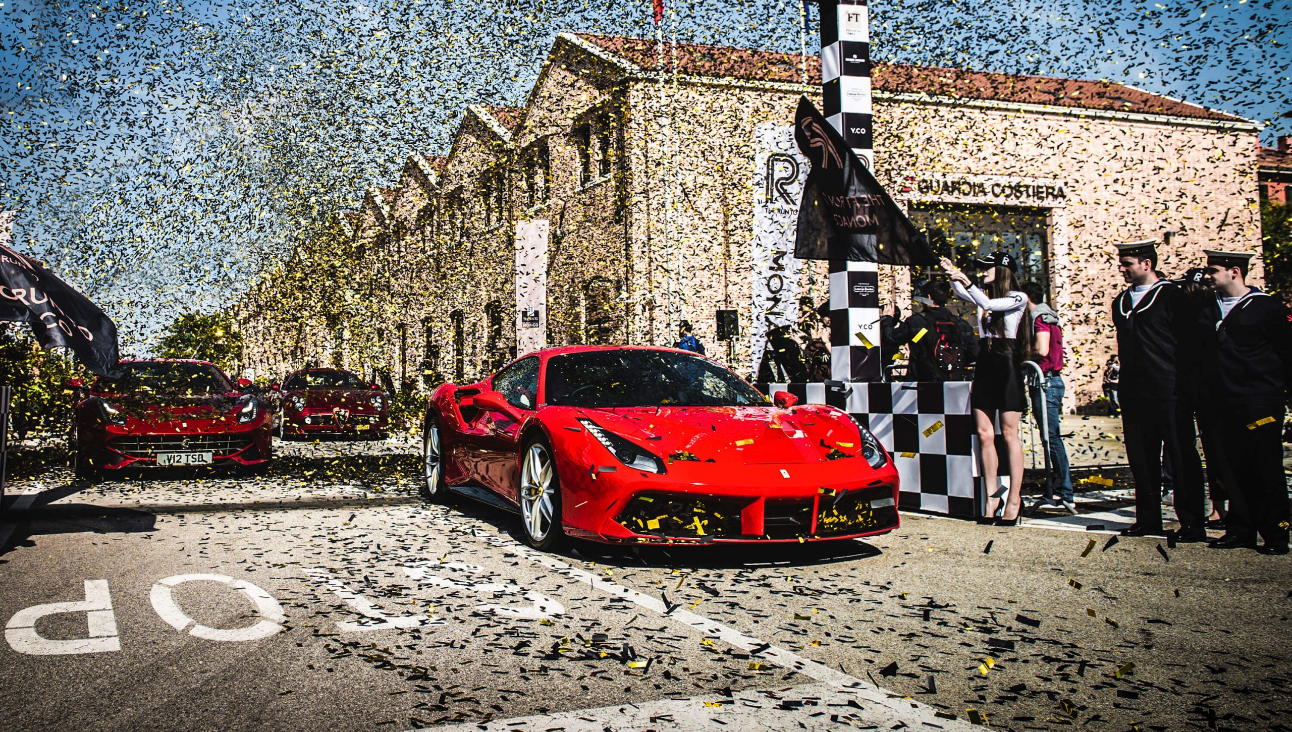 Red Ferrari on the start line of the Run to Monaco 2016 in Venice covered in confetti