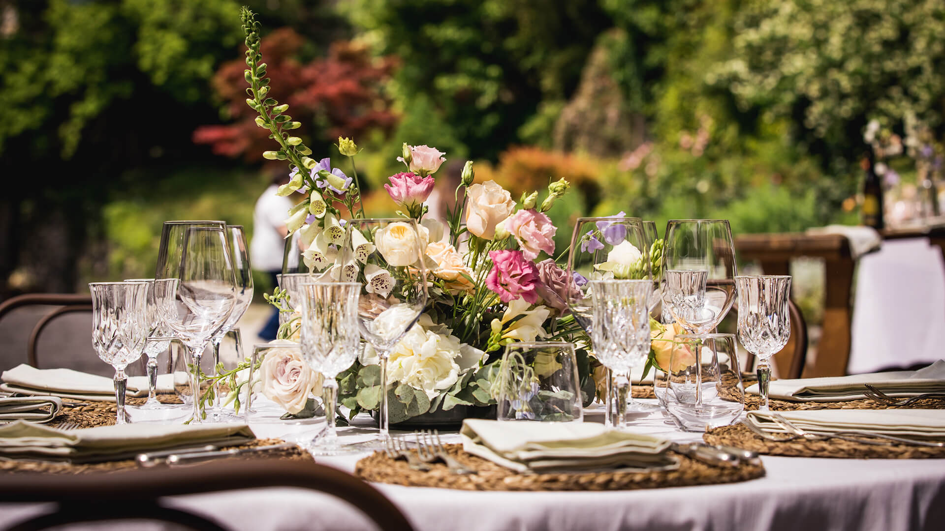 A table laid with flowers ready for guests to arrive for an al fresco lunch